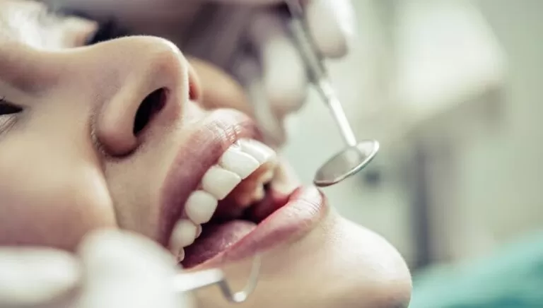 Dentists treating patient's teeth